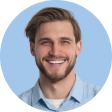 A headshot of Chris on a blue background